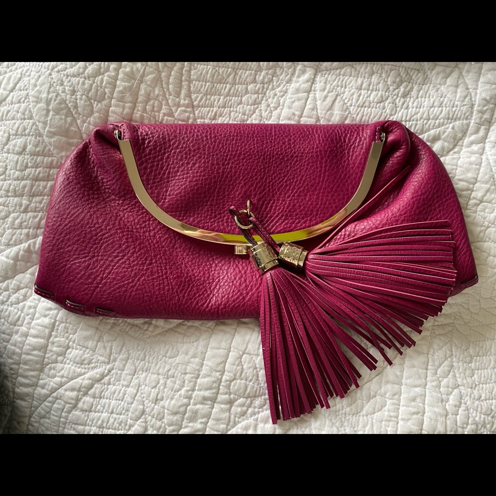 Tumi pink leather clutch w/purple lining and tassels